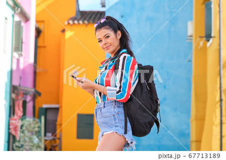 young happy traveler woman posing among colorful young happy traveler woman posing among colorful 67713189