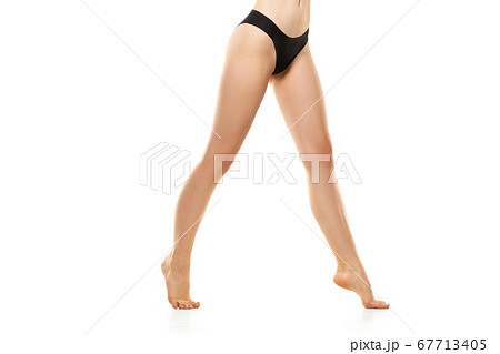 Beautiful female legs, buttlocks and belly isolated on white background. Sportive, sensual body with well-kept skin in underwear. Beautiful female legs, buttlocks and belly isolated on white background. Sportive, sensual body with well-kept skin in underwear. 67713405