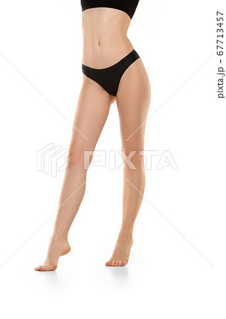 Beautiful female legs, buttlocks and belly isolated on white background. Sportive, sensual body with well-kept skin in underwear. Beautiful female legs, buttlocks and belly isolated on white background. Sportive, sensual body with well-kept skin in underwear. 67713457