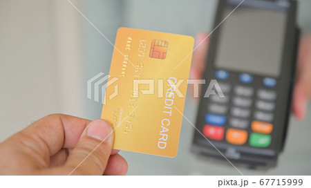 Close - up shot of Customers pay by credit card Close - up shot of Customers pay by credit card 67715999