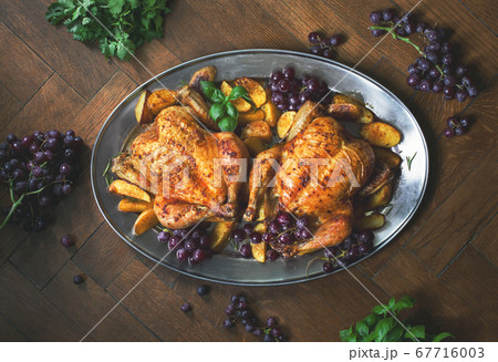 Oven roasted chicken served with baked potato Oven roasted chicken served with baked potato 67716003