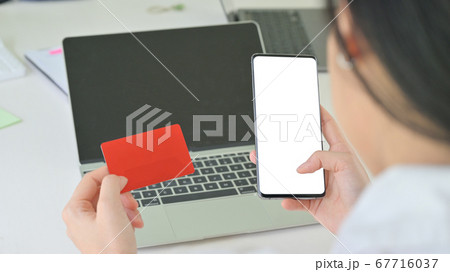 Credit card and smartphone in the woman hand and 67716037