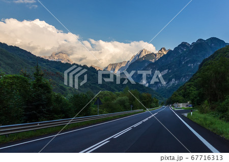 Empty road in the Alps valley, Italy 67716313