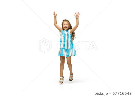 Happy little caucasian girl jumping and running isolated on white background Happy little caucasian girl jumping and running isolated on white background 67716648