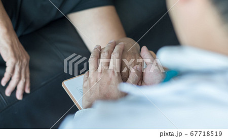 Parkinson disease patient, Alzheimer elderly senior, Arthritis person's hand in support of geriatric doctor or nursing caregiver, for disability awareness day, ageing society care service 67718519