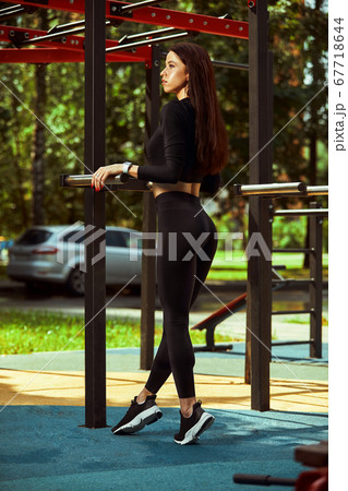 Strong and sexy sportive woman training outdoors, on the ground 67718644