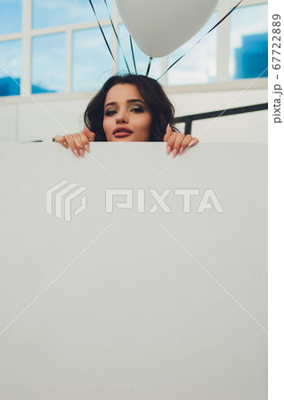 Young woman hiding in a carton box. 67722889