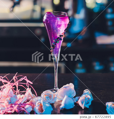 bright cocktail in a beautiful glass neon lighting background. bright cocktail in a beautiful glass neon lighting background. 67722895