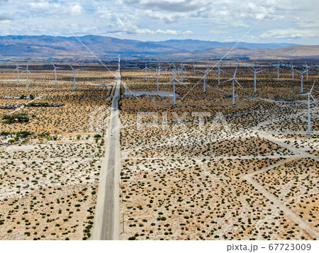Aerial view of huge array of gigantic wind turbines spreading over the desert in Palm Springs. 67723009