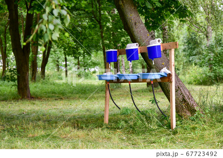 Hand washing in a public park Hand washing in a public park 67723492