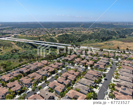 Aerial view of upper middle class neighborhood with residential houses in green valley  67723527