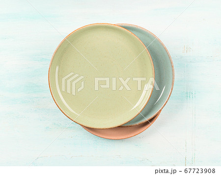 Pastel color dishes on turquoise background 67723908