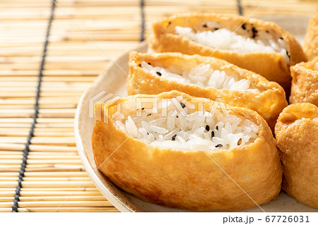 黒ごま入りのいなり寿司。背景、すだれ。 67726031