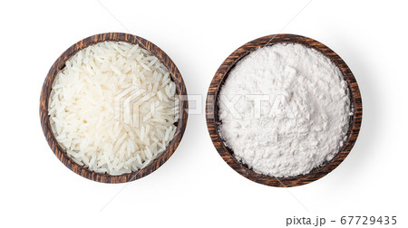 rice grains and pile of flour in wood bowl rice grains and pile of flour in wood bowl 67729435
