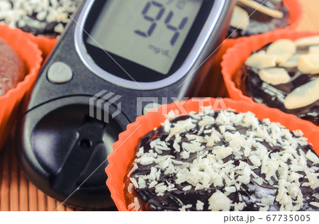 Glucometer for checking sugar level and fresh muffins 67735005