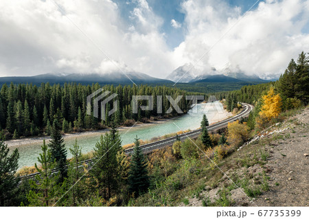 Railway with rocky mountains and cloudy in autumn 67735399