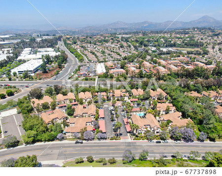Aerial view middle class neighborhood with condo community and residential house, South California 67737898