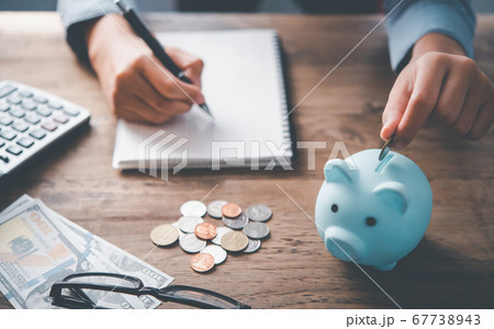 Hand holding coin with pig piggy bank. Hand holding coin with pig piggy bank. 67738943