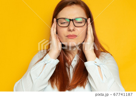 Depression unhappy woman with bipolar disorder clings to her head and experiences a headache. Depression unhappy woman with bipolar disorder clings to her head and experiences a headache. 67741187