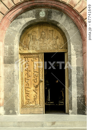 Entrance doors with Armenian alphabet on the facade of the Church of St. Mesrop Mashtots in the village of Oshakan Entrance doors with Armenian alphabet on the facade of the Church of St. Mesrop Mashtots in the village of Oshakan 67741649
