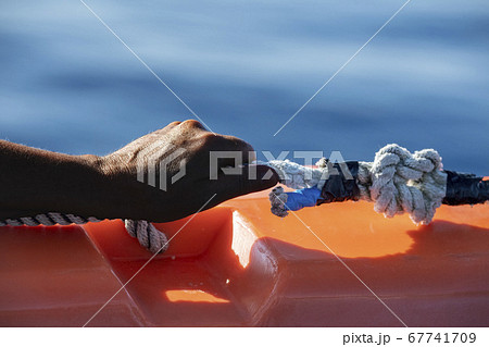 hand of black Migrant detail on boat hand of black Migrant detail on boat 67741709