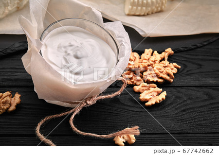 Yogurt or sour cream in rustic bowl on wooden background, top view 67742662