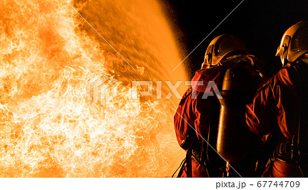 Firefighters use twirl water fog spraying down Firefighters use twirl water fog spraying down 67744709
