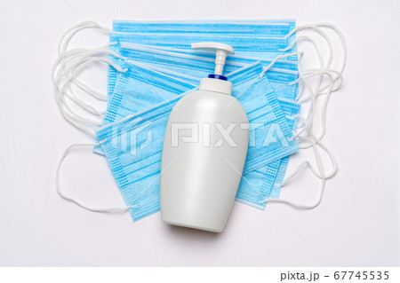 bottle of lotion, sanitizer or liquid soap and medical protective mask isolated on white background with clipping path 67745535