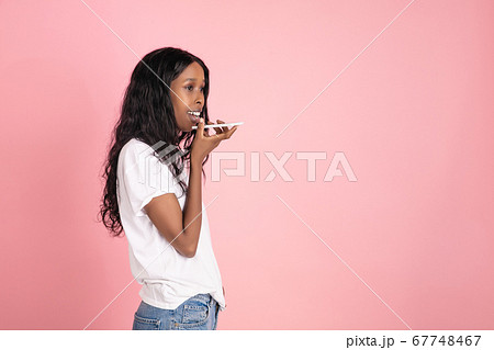 Cheerful african-american young woman isolated on pink background, emotional and expressive Cheerful african-american young woman isolated on pink background, emotional and expressive 67748467