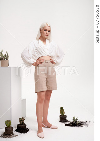 Portrait of female model posing in studio. 67750550