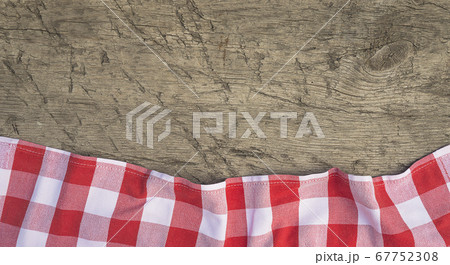 Background with red and white checkered napkin on old wooden planks 67752308