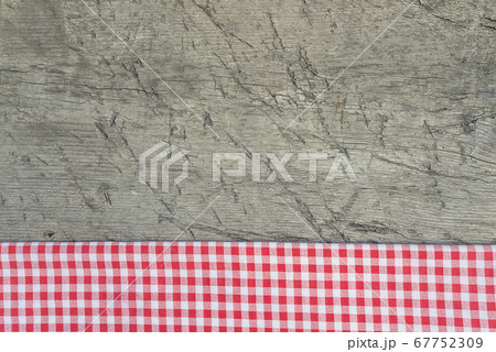 Red and white checkered napkin on rustic wooden planks 67752309
