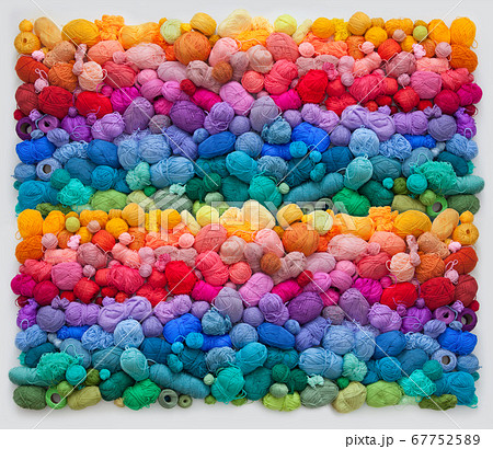 Colored balls and skiens of yarn for knitting. Top view. Rainbow colors. Color horizontal gradient. 67752589