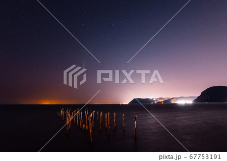 Comet C/2020 NEOWISE at night star sky with sea, birds and city lights 67753191