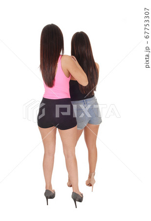 Two women standing from the back in jeans shorts 67753307