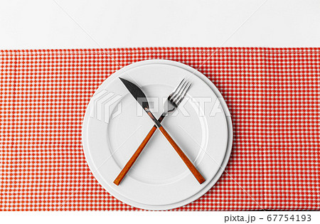 Fork, knife and plate on towel. Isolated on white background. 67754193