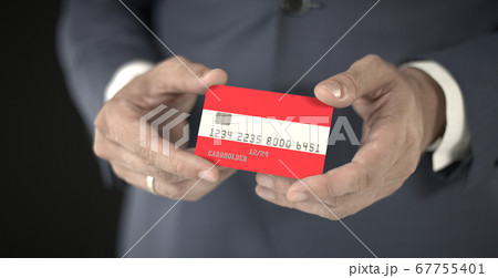 Businessman holding plastic bank card with printed flag of Austria, fictional numbers Businessman holding plastic bank card with printed flag of Austria, fictional numbers 67755401