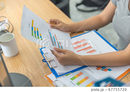 Asian manager checking financial sales reports in her business office 67755720
