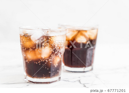 glass of cola with ice 67771201
