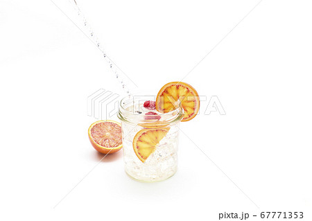 Gin and tonic in a glass jar with orange and 67771353