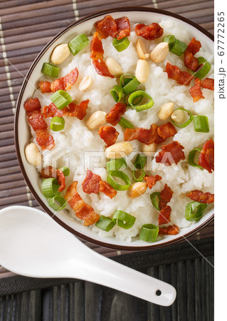 Rice porridge with bacon, peanuts and green onions 67772265