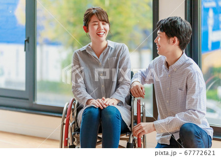 車椅子の女性と男性のカップル  67772621