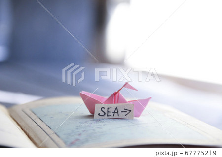 Sea idea. Paper boat on the map and inscription. Sea idea. Paper boat on the map and inscription. 67775219