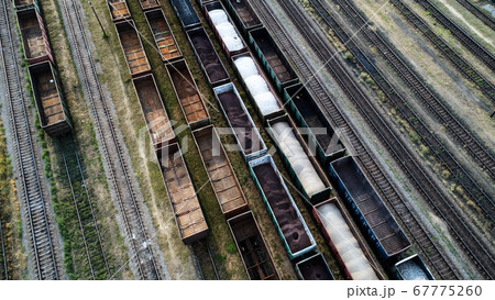 Aerial view of rail sorting freight station with railway cars, with many rail tracks railroad. Heavy industry landscape. 67775260