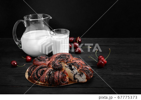 Homemade roll with poppy seeds and milk for breakfast 67775373