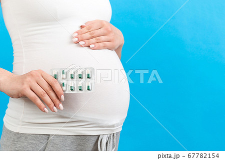 Close up of a blister of pills in pregnant woman's Close up of a blister of pills in pregnant woman's 67782154