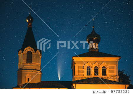 Korma Village, Dobrush District, Belarus. Comet Neowise C2020f3 In Night Starry Sky Above St. John The Korma Convent Church In Korma Village. Famous Orthodox Church And Historic Heritage Korma Village, Dobrush District, Belarus. Comet Neowise C2020f3 In Night Starry Sky Above St. John The Korma Convent Church In Korma Village. Famous Orthodox Church And Historic Heritage 67782583
