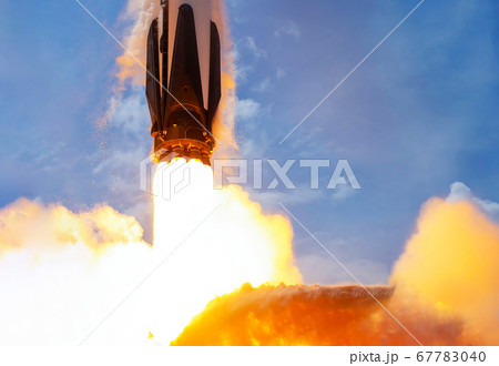 Rocket launch against blue sky 67783040