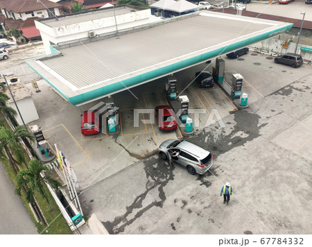 Petronas petrol station during the daytime. Customers come to visit this petrol station to refuel, buy groceries or use the facilities provided. 67784332
