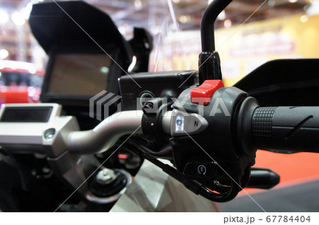 KUALA LUMPUR, MALAYSIA -JULY 25, 2019: Motorcycle ignition and engine kill button. Placed at the right-hand side of the motorcycle handle. It is usually red. 67784404